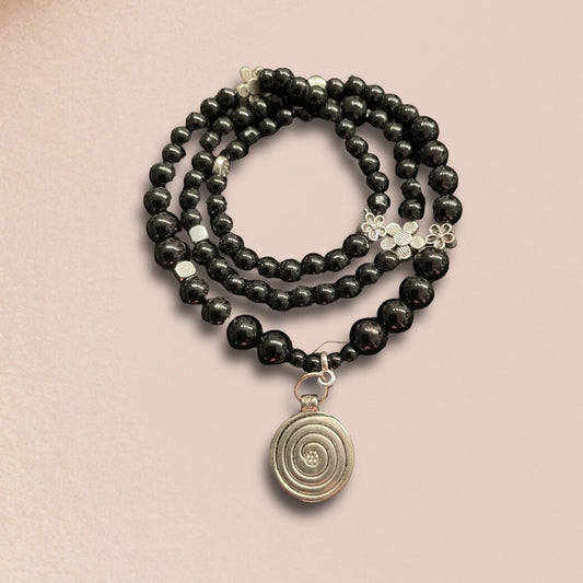 Handmade Wickelarmband in schwarz mit einem Anhänger Spirale