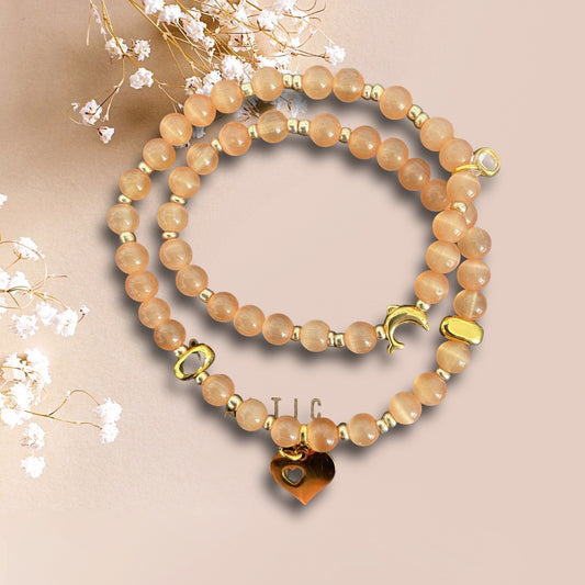 Armband PHETRUNG aus schimmernden cateye Perlen mit  einem Herz Anhänger