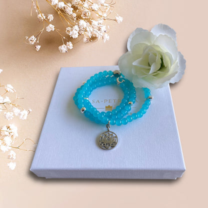 Armband aus Cateye Perlen in türkis mit einer Buddha Perle und einem Anhänger Lotusblume