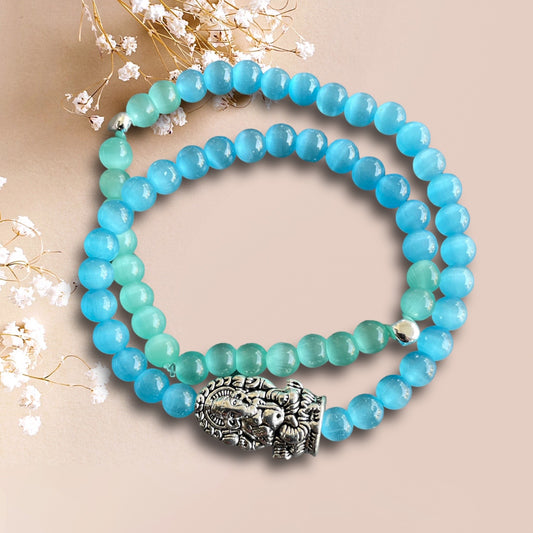 Armband BALI aus cateye Perlen in türkis mit einer Perle mit dem Motiv Ganesha