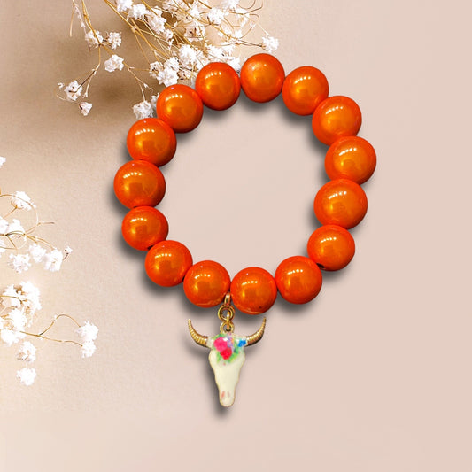 Armband COACHELLA aus Miracle Perlen in orange mit einem Anhänger Stierkopf