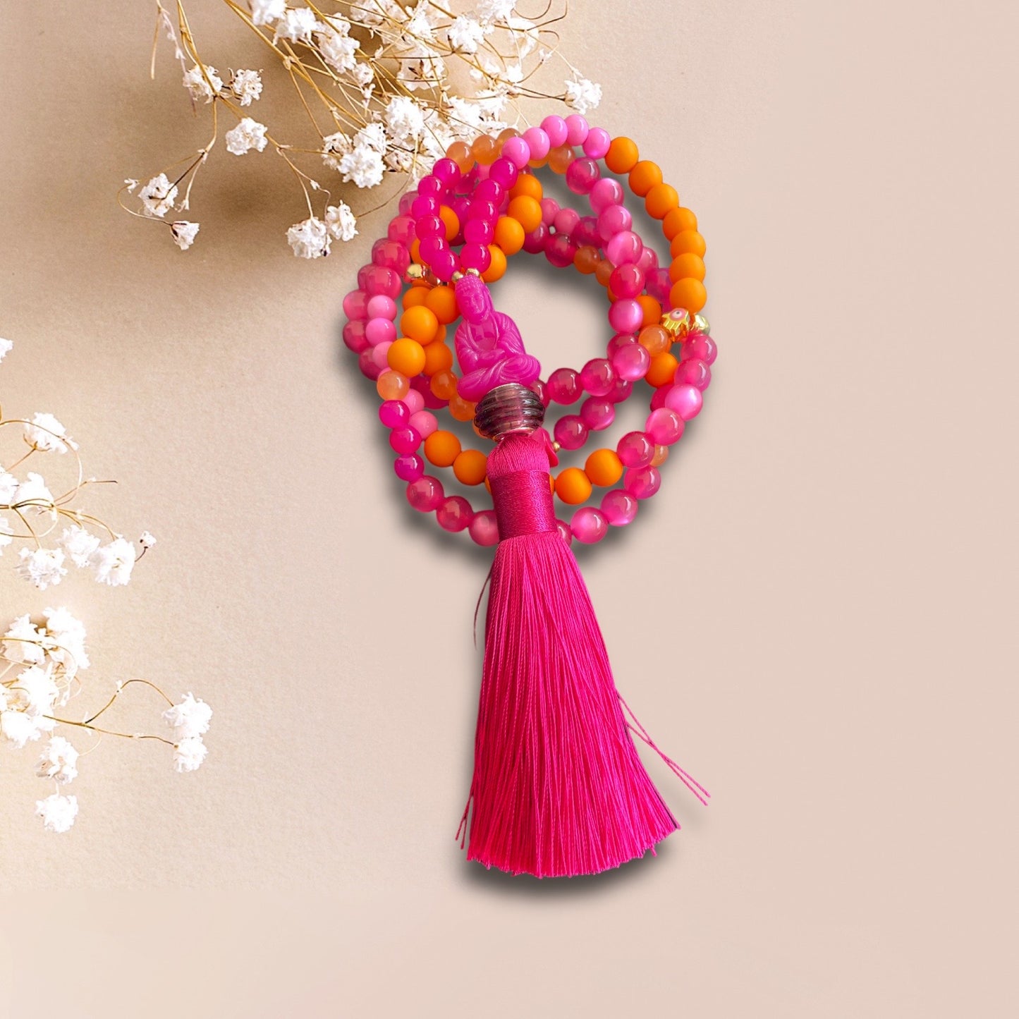 Kette AURI aus Perlen in pink und orange mit einer Buddha Perle und Quaste in pink
